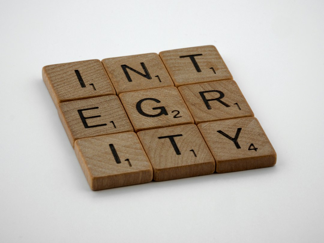 a scrabbled wooden block with the words integr city on it