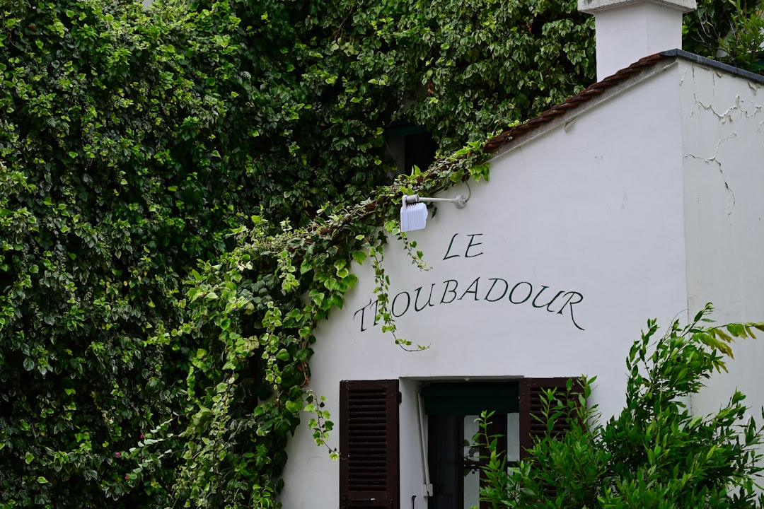 A white building with a clock on the side of it